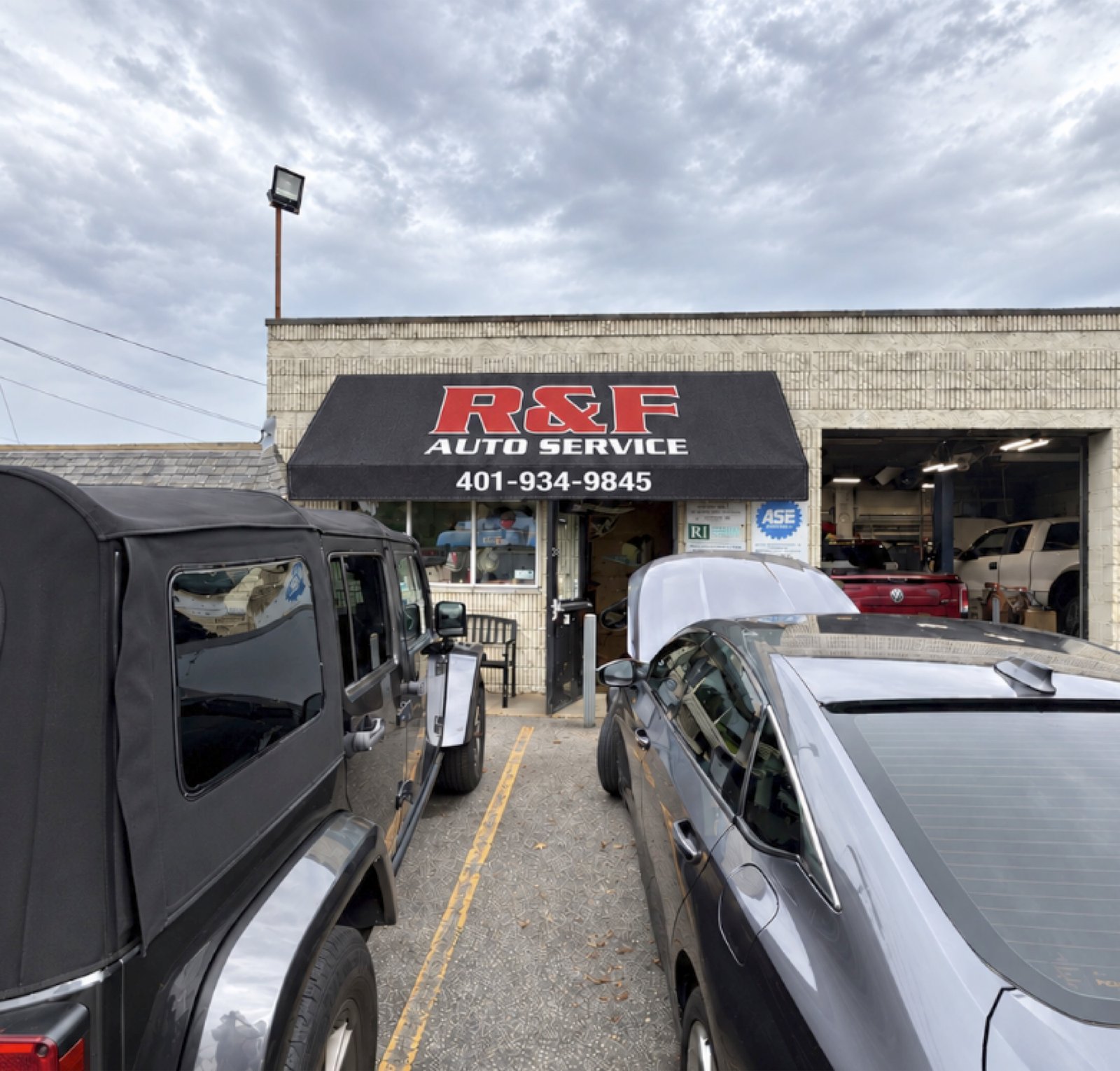 Black R&F awning concept with red and white lettering on the existing frame